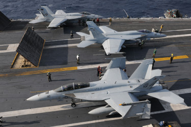 US_Navy_101209-N-9693M-009_Two_F-A-18E_Super_Hornets_prepare_for_a_catapult_assisted_launch_as_an_F-A-18E_Super_Hornet_taxis_toward_the_aft_of_USS